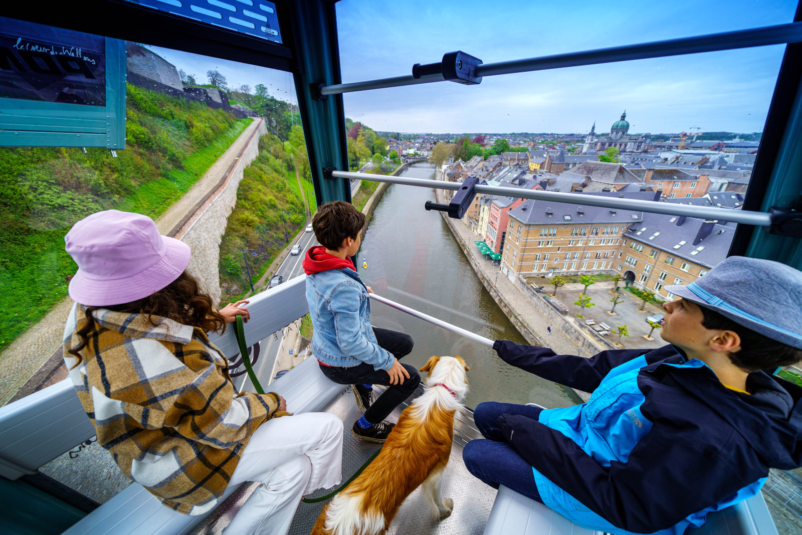 Family and their dog on the cable car in Namur