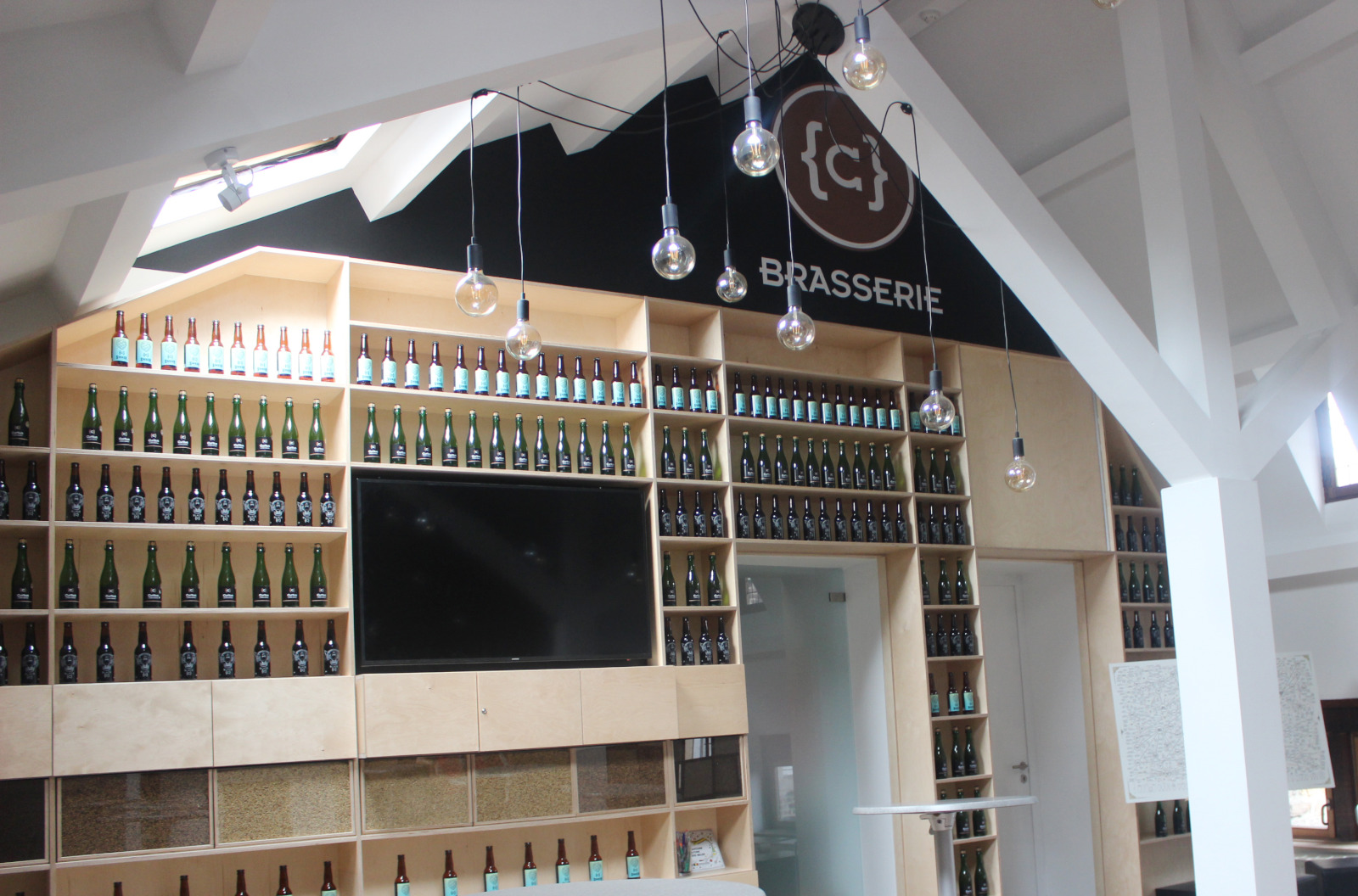 Wall of beer bottles inside the Brasserie C microbrewery in Liège - gourmet tour of Liège