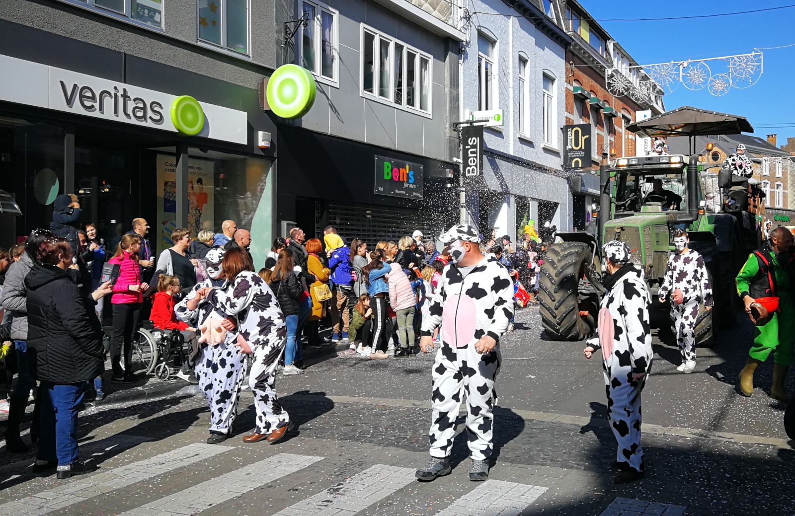 People dressed as cows parading through the village streets