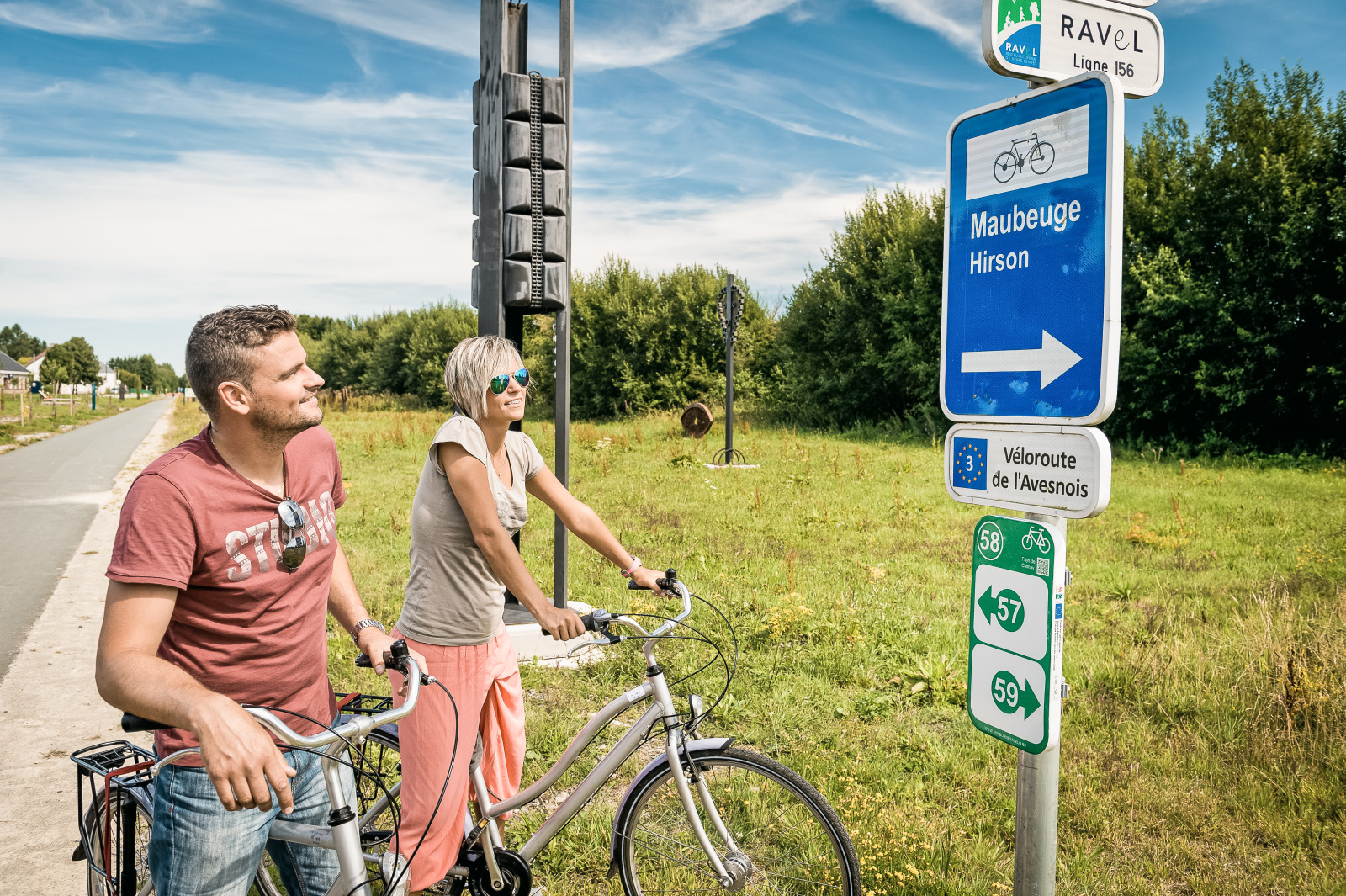 Couple in front of a RAVeL sign in the province of Hainaut
