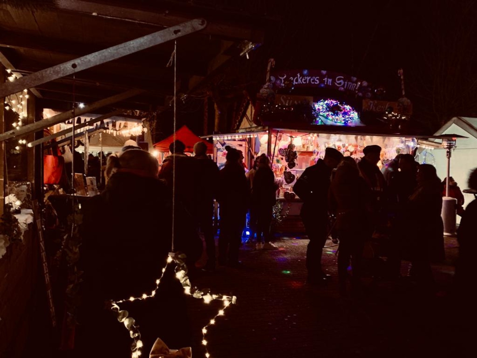 Christmas market aisles with illuminated wooden chalets