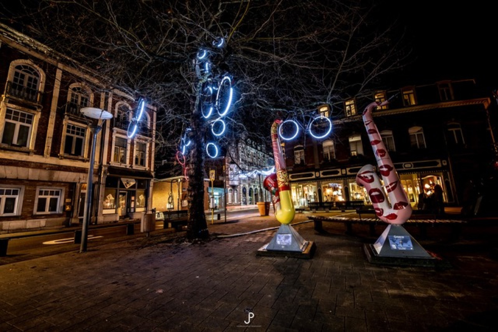 Rue décorée de vélos lumineux suspendus 
