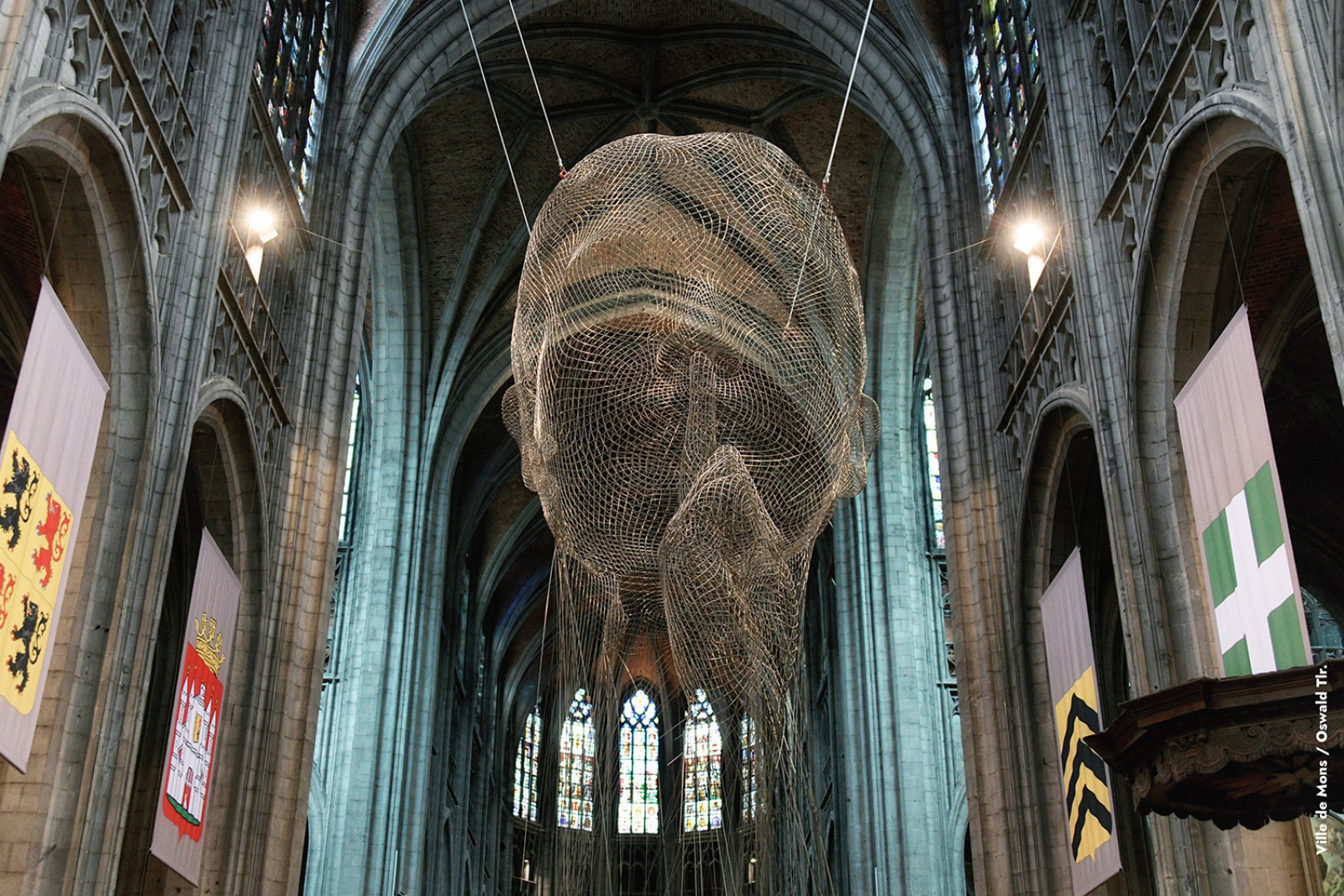 Carved face, suspended in the center of a church