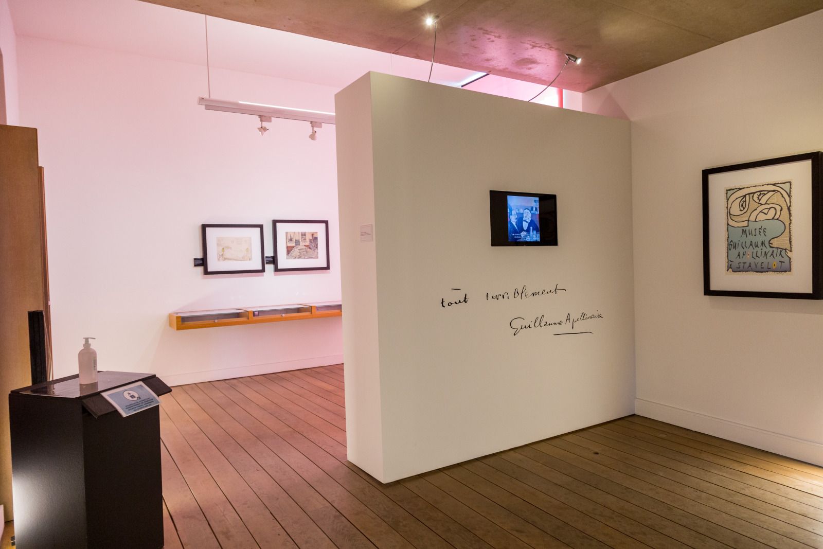 Exhibition room with writings by Guillaume Apollinaire and portraits of the artist