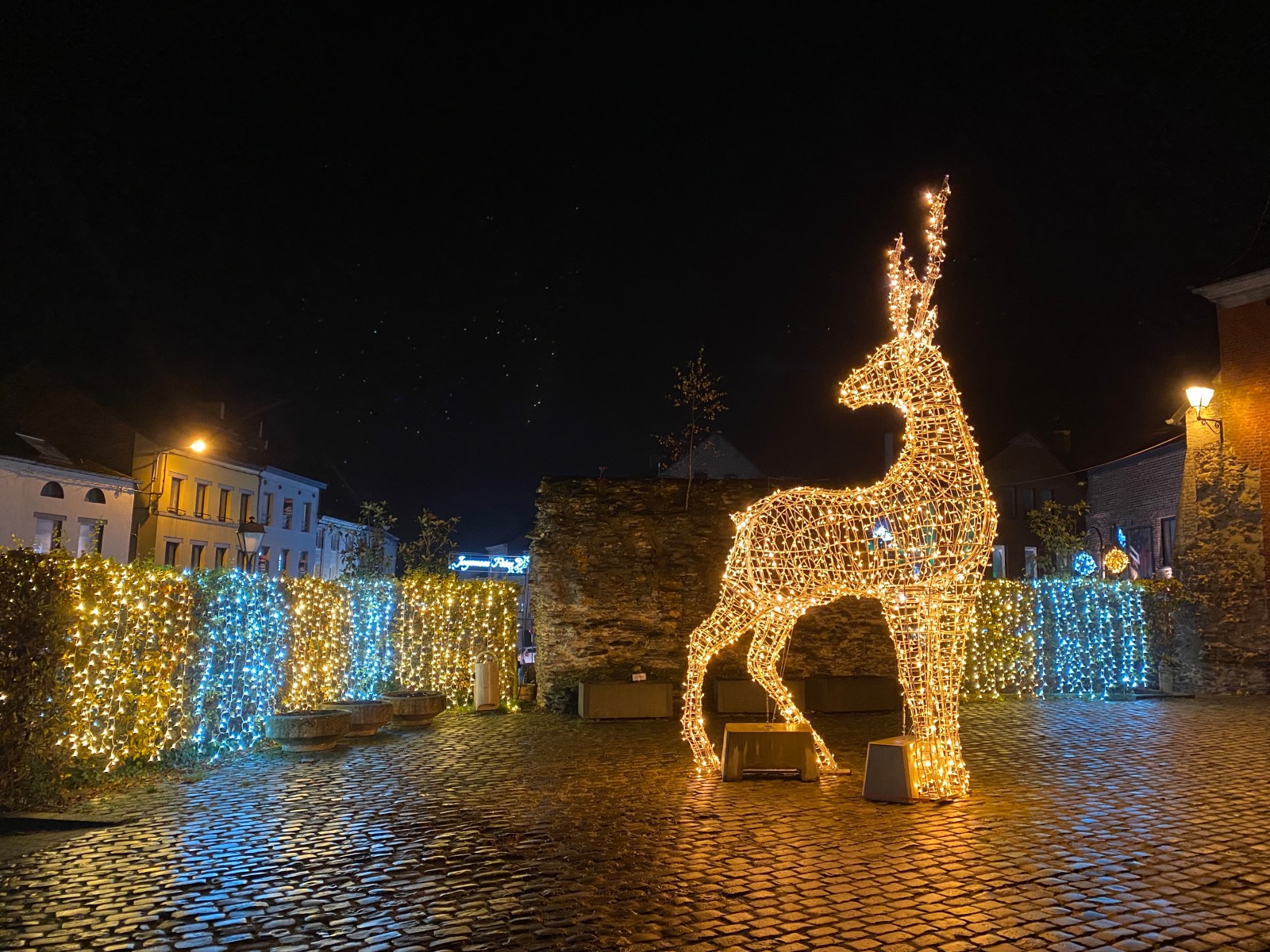 Lit statue representing a reindeer, set on the village square