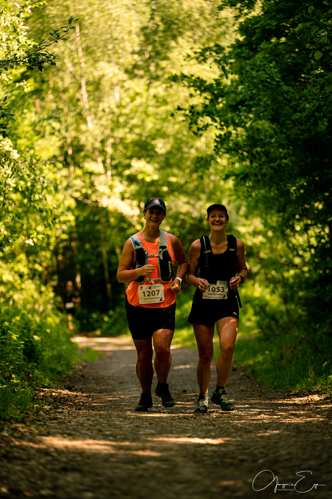 Two trail runners in the heart of the forest