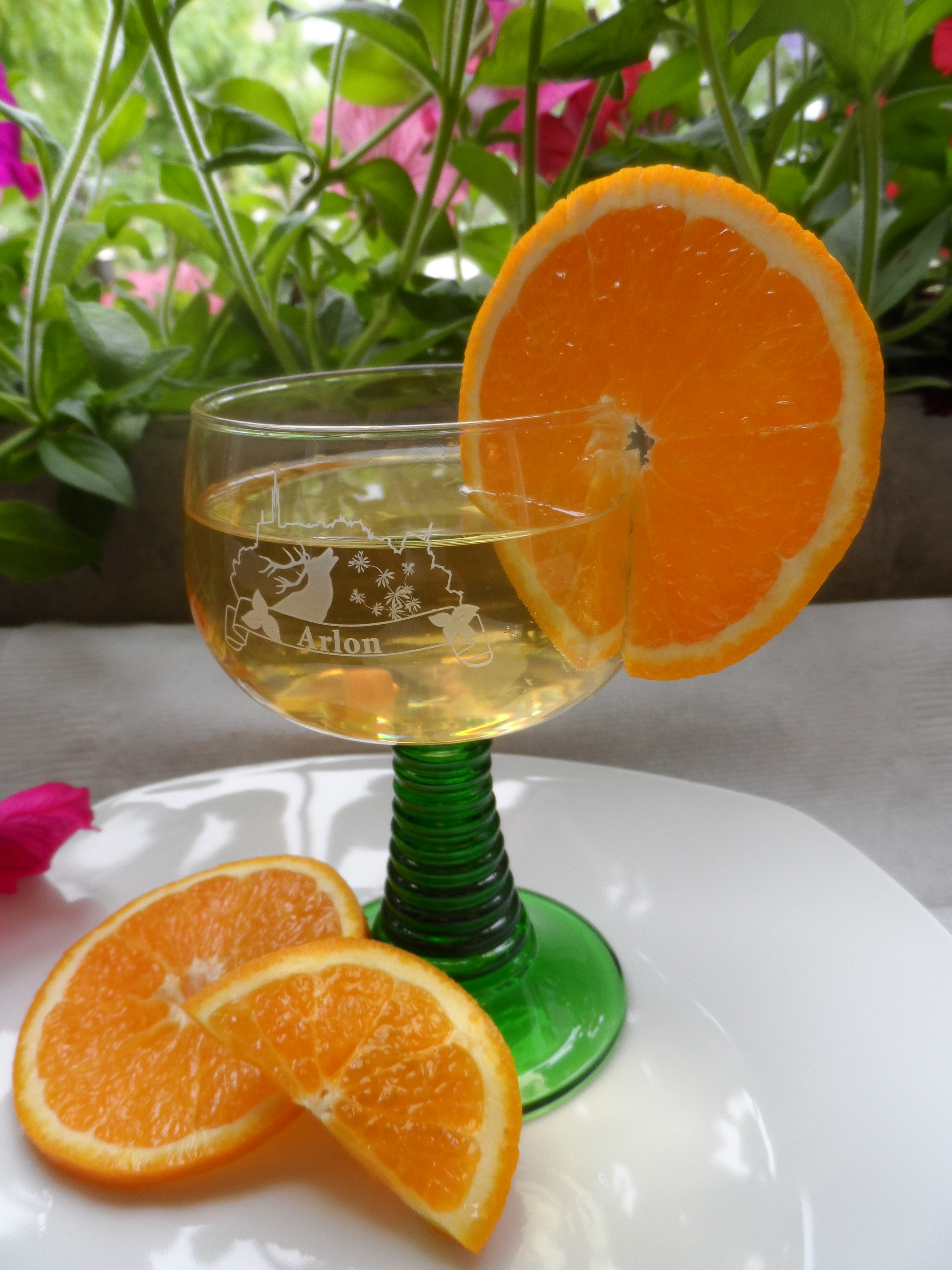 Glass of Maitrank with orange slices on the side