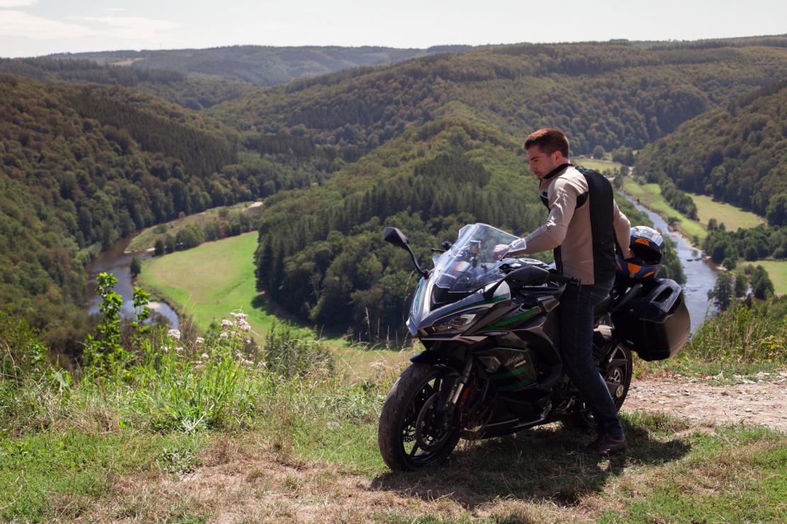 Motard et sa moto devant le point de vue du Tombeau du géant