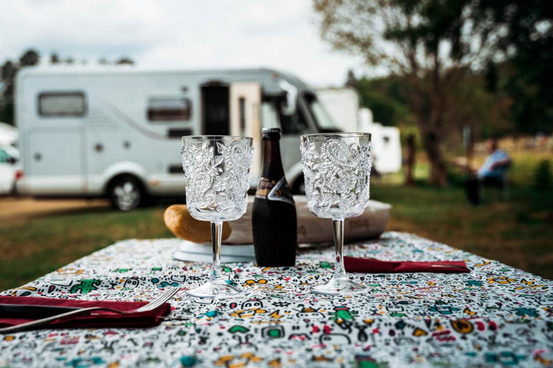 Table set with beer, camper van in the background