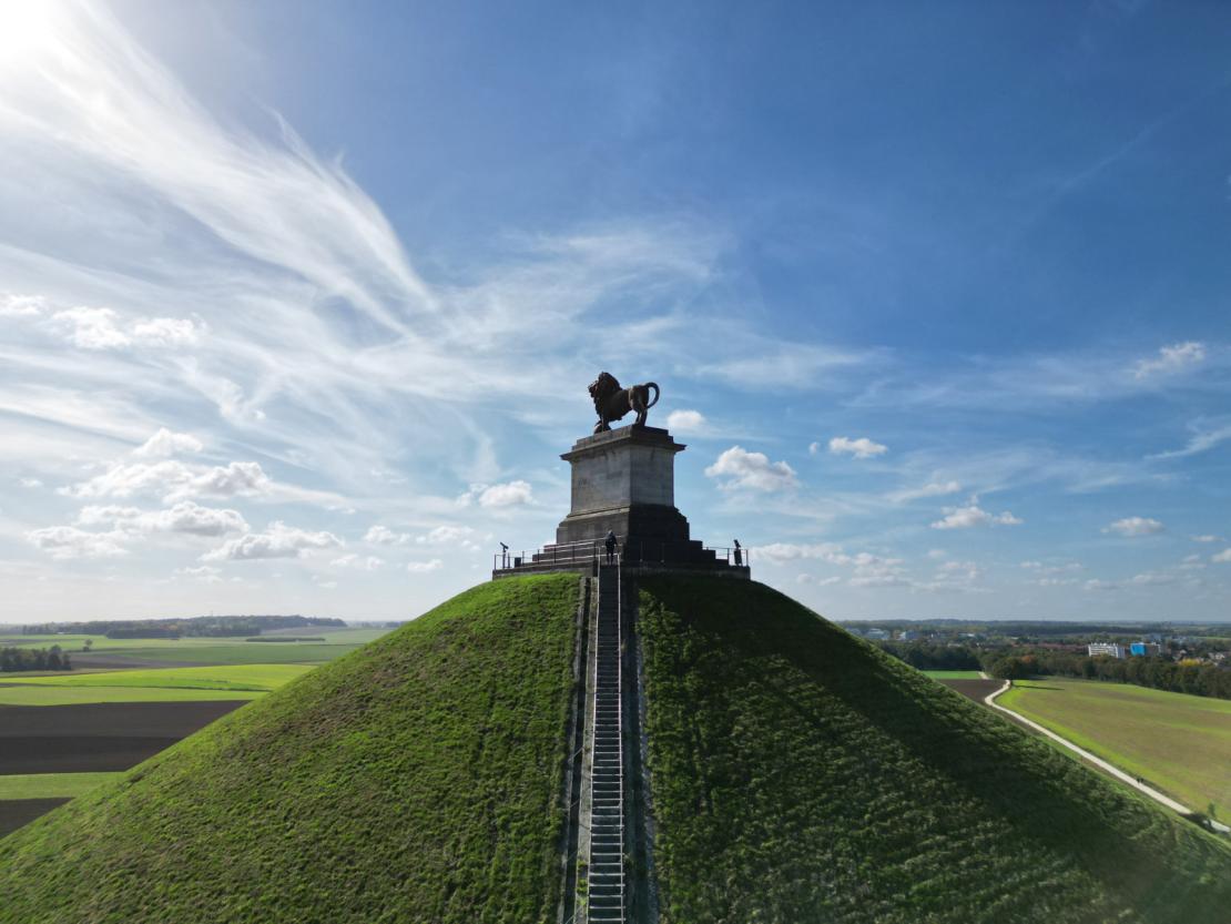 Waterloo Lion's Mound and surrounding countryside under a blue sky