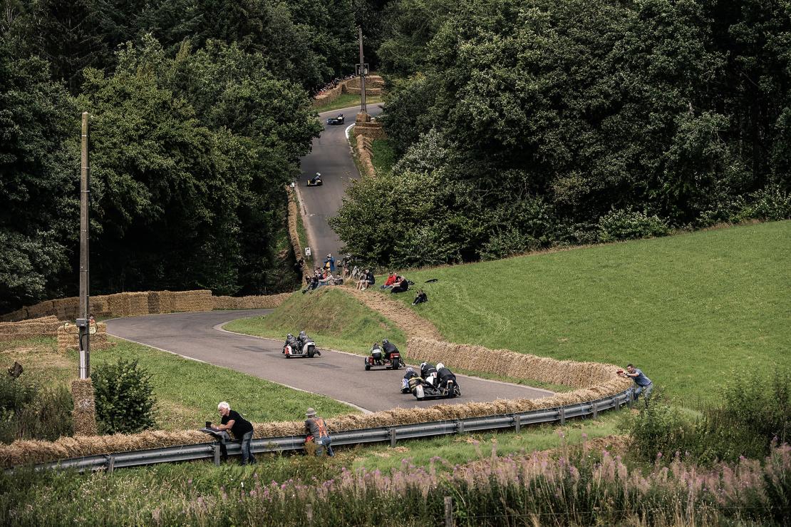 Motorcycle side cars participating in a competition across the Gedinne countryside