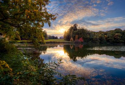 Coucher de soleil aux étangs et au parc du Domaine régional Solvay avec le château de La Hulpe situé au fond.