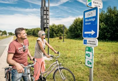 Couple in front of a RAVeL sign in the province of Hainaut