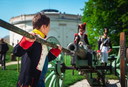 Un enfant habillé en soldat napoléonien charge un canon lors de la reconstitution de la Bataille de Waterloo
