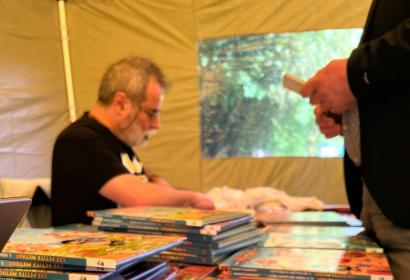 Personne dédicaçant une BD