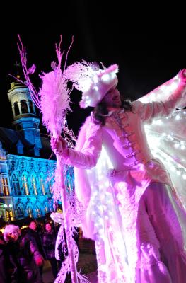 Illuminated winged character strolling through the Christmas market