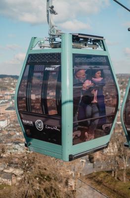 A couple looks at Namur from their cable car cabin