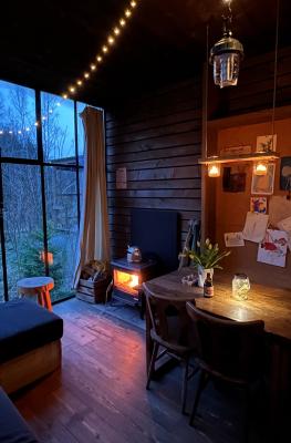 Cozy interior with a wood stove in a cabin in Nutchel (Martelange)