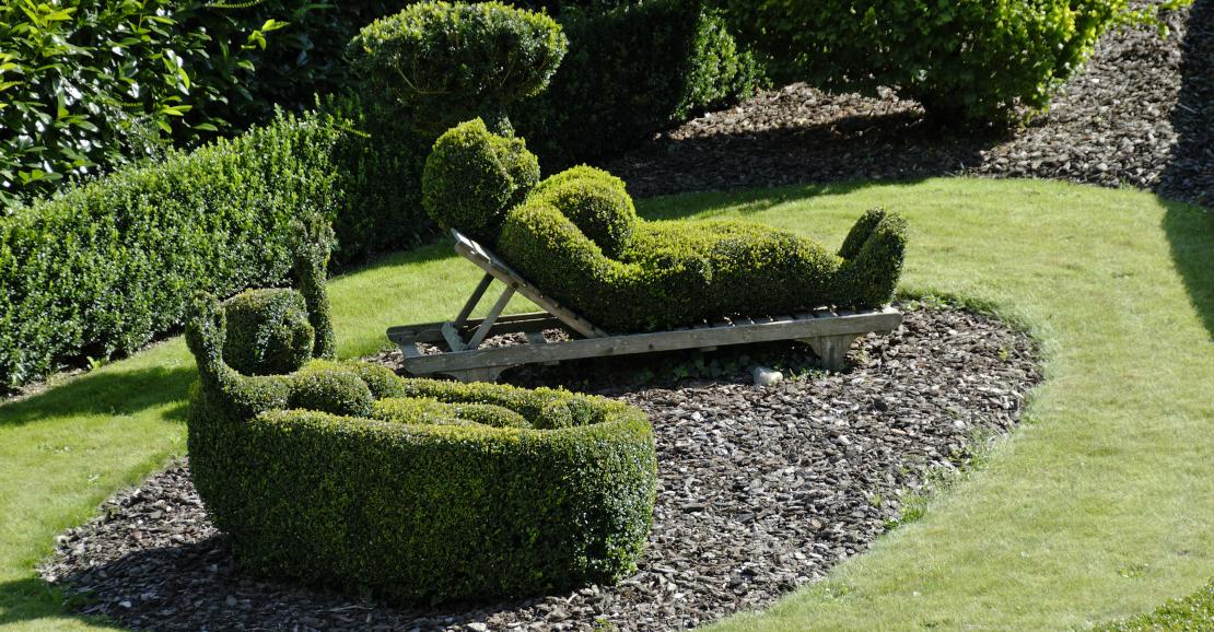 Bushes cut in the shape of men lying down at the Parc des Topiaires in Durbuy